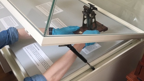 A work experience student installs a display they curated