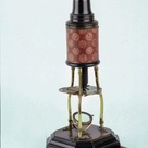 Detail showing the stage and objective lens of the 1730s microscope used to take the image of a flea, shown below.