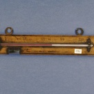 Wooden framed thermometer by W. E. Pain.