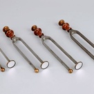 Lissajous tuning forks with attached mirrors for projecting Lissajous figures