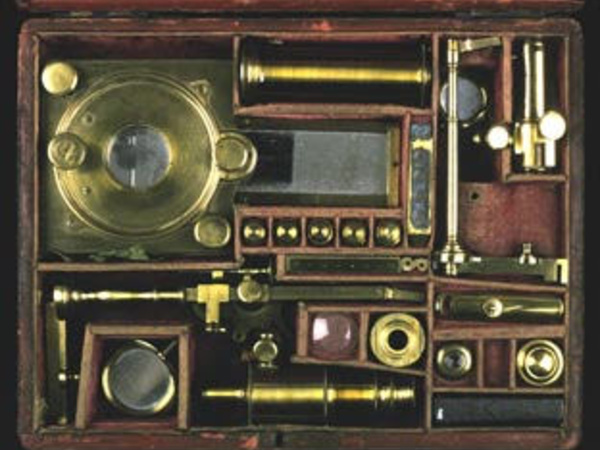 A microscope compendium, with all parts disassembled and packed away in a case.