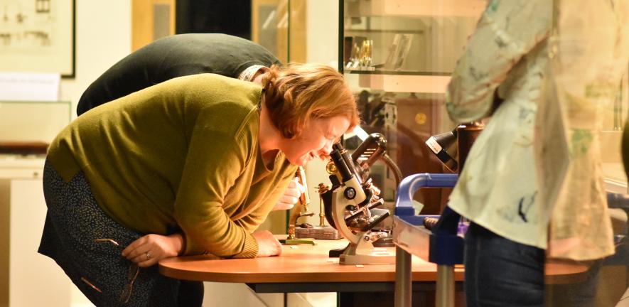 Woman looking into a microscope