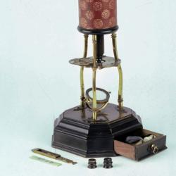 Detail showing the stage and objective lens of the 1730s microscope used to take the image of a flea, shown below.