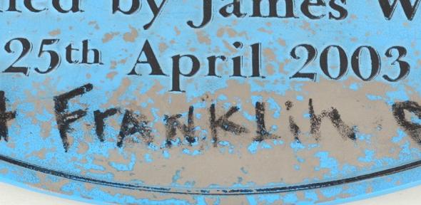 blue plaque, removed from The Eagle pub, commemorating Watson and Crick's announcement of the discovery of DNA structure, with '+franklin' in graffito