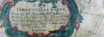 Detail of globe showing inscription "A New TERRESTRIAL GLOBE, Made by Rt Morden, Wan Berry, Ph Lea. And Sold at their Shops at the Atlas in Cornhill, at ye Globe at Chering Cross, and at ye Atlas of Hercules in Cheapside, London.